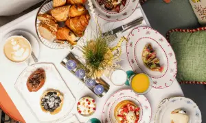 Un plateau de viennoiseries, tartes, œufs, jus et café pour un meilleur brunch parisien.