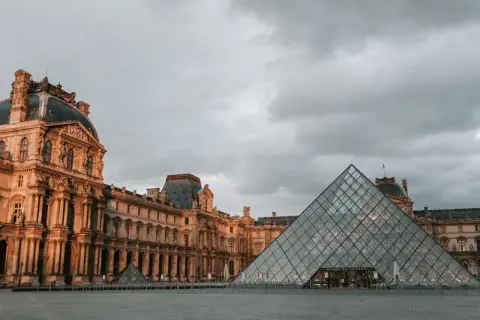 La pyramide du Louvre et le palais sous un ciel gris, un décor typique de Paris en janvier.