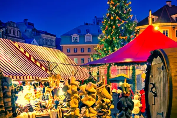 Ambiance féerique d'un marché de Noël en Île-de-France, avec un sapin illuminé, des chalets colorés et des décorations festives.